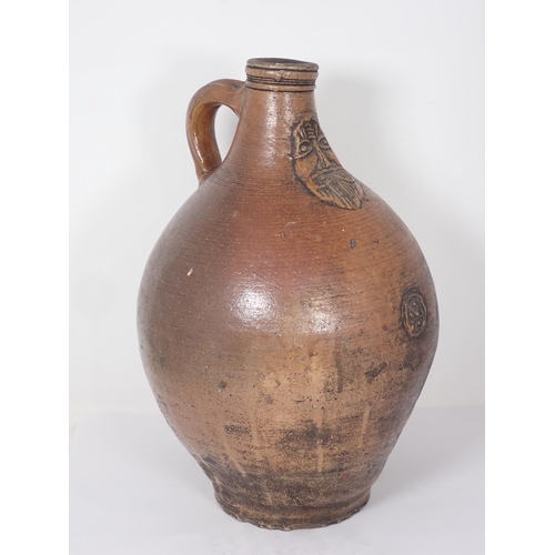 287 - A 17th Century stoneware salt glazed Bellarmine Wine Jug with orange tiger glaze and mask decoration... 