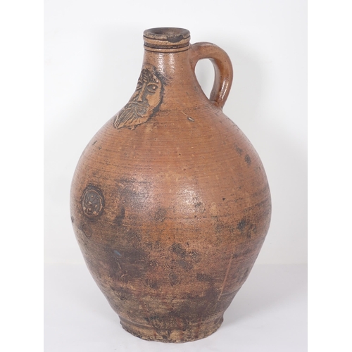 287 - A 17th Century stoneware salt glazed Bellarmine Wine Jug with orange tiger glaze and mask decoration... 