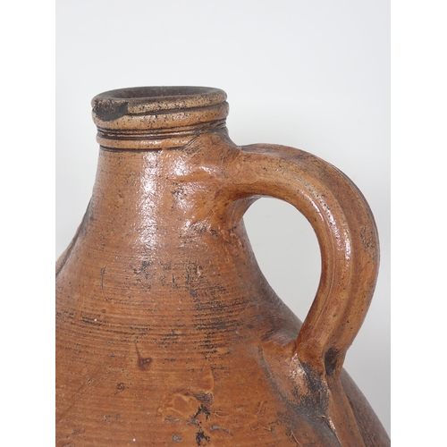 287 - A 17th Century stoneware salt glazed Bellarmine Wine Jug with orange tiger glaze and mask decoration... 