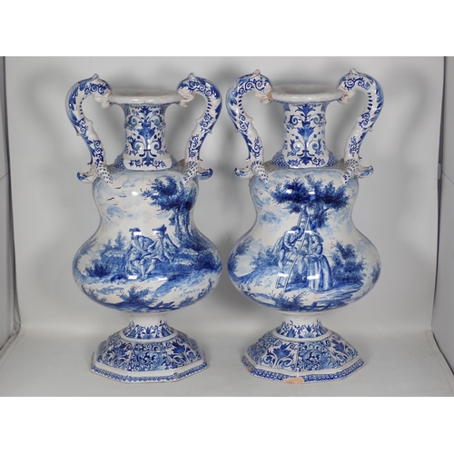 288 - An impressive pair of 19th Century Dutch Delft two handled Vases with narrow cannon barrel necks abo... 