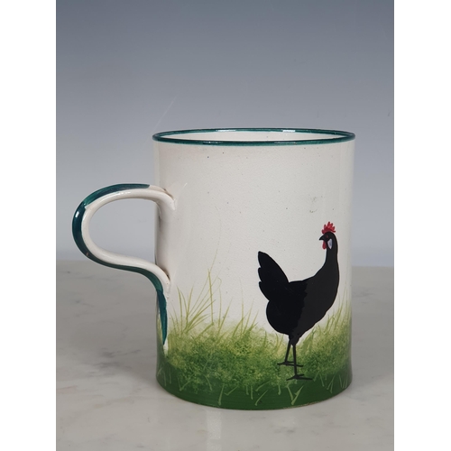 297 - A Wemyss Ware large Mug, decorated chickens, with green rim and handle, 5½in H, impressed mark and o... 