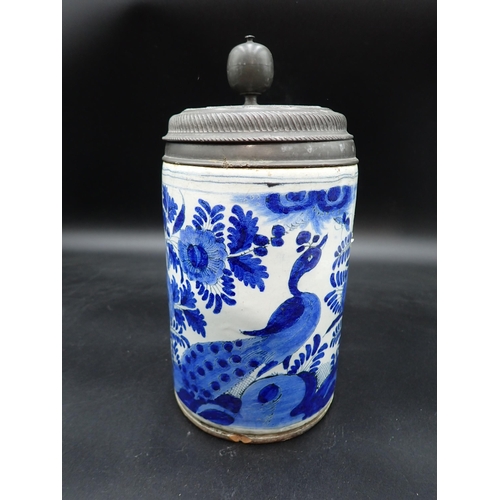 304 - A large antique Delft blue and white Tankard, painted bird amongst flowering shrubs, pewter lid with... 