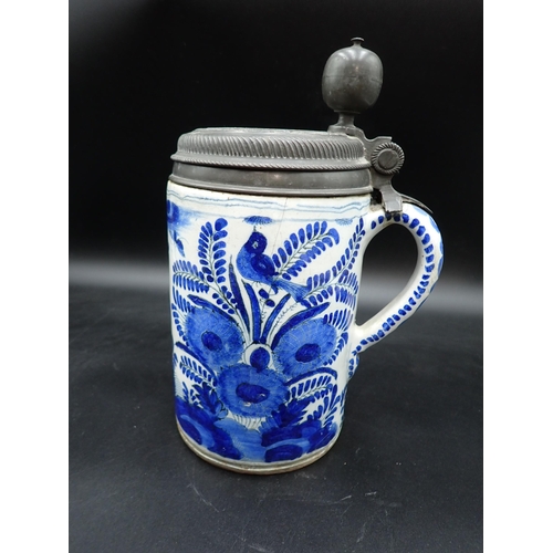 304 - A large antique Delft blue and white Tankard, painted bird amongst flowering shrubs, pewter lid with... 