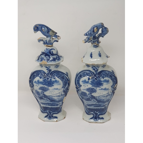 313 - A pair of 19th Century Dutch delft lidded Vases with bird finials and panels of boy fishing A/F 12in... 