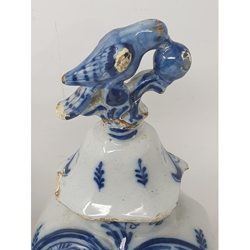 313 - A pair of 19th Century Dutch delft lidded Vases with bird finials and panels of boy fishing A/F 12in... 