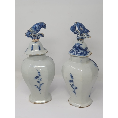 313 - A pair of 19th Century Dutch delft lidded Vases with bird finials and panels of boy fishing A/F 12in... 