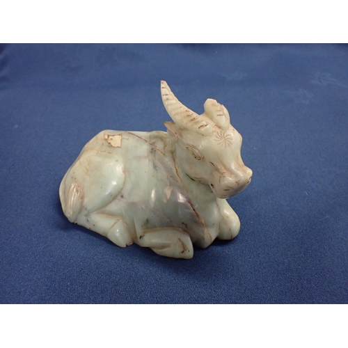 324 - An Oriental jade type recumbent Buffalo, 6in, A/F