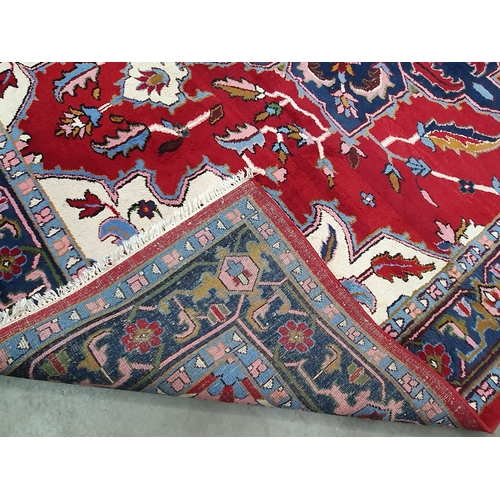 381 - A Persian Carpet with multiple borders, stylised floral designs with a central blue star medallion o... 