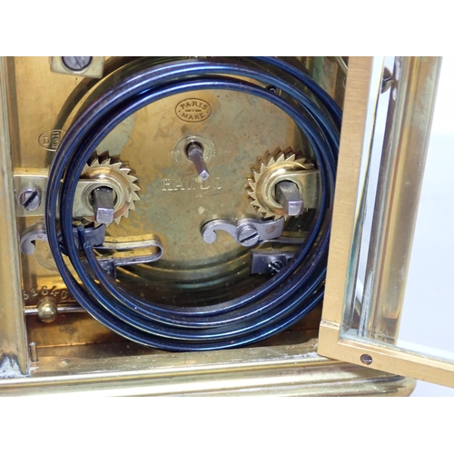 401 - A late 19th Century brass cased Carriage Clock with white enamel dial, lever escapement, hour repeat... 