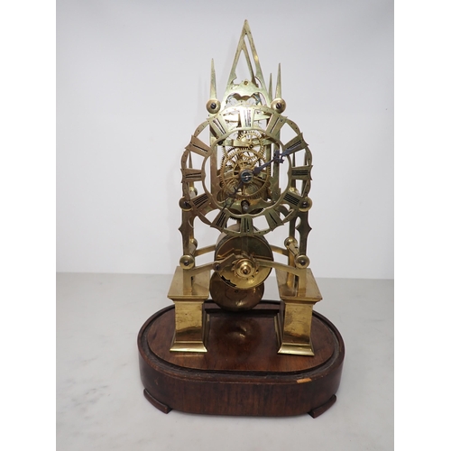 402 - A 19th Century gothic style brass Skeleton Clock with single train fusee movement, on oval rosewood ... 