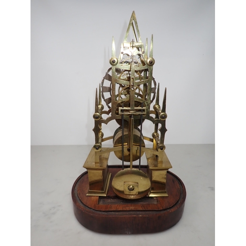 402 - A 19th Century gothic style brass Skeleton Clock with single train fusee movement, on oval rosewood ... 