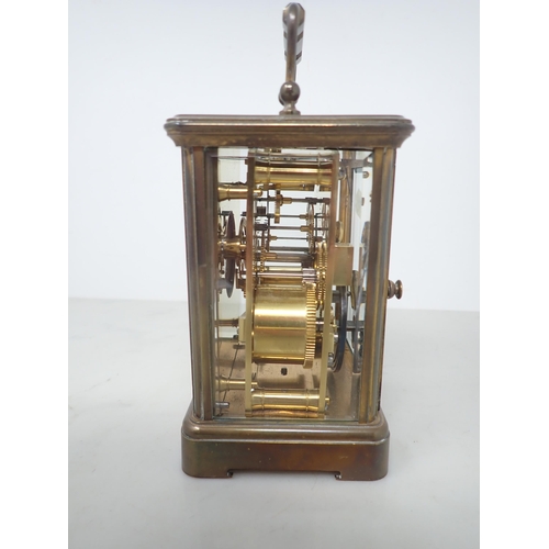 404 - A French brass cased Carriage Clock with white enamel circular dial, lever escapement, striking on c... 