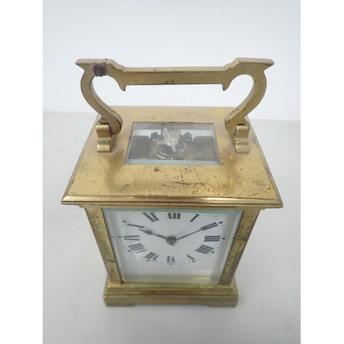 405 - A French brass cased Carriage Clock with white enamel rectangular dial, lever escapement striking on... 