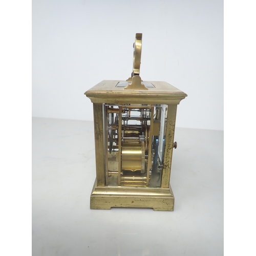 405 - A French brass cased Carriage Clock with white enamel rectangular dial, lever escapement striking on... 