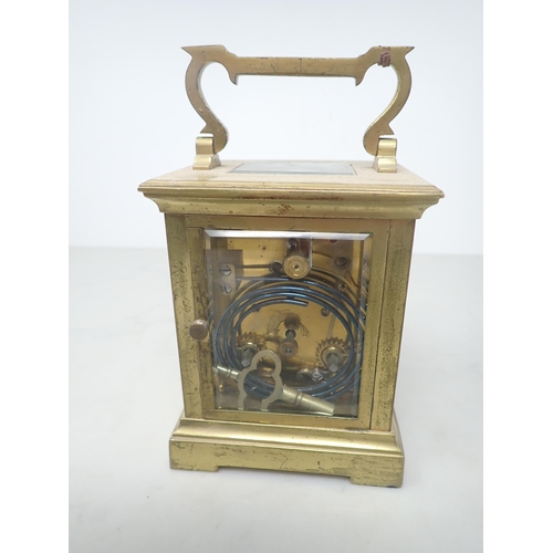 405 - A French brass cased Carriage Clock with white enamel rectangular dial, lever escapement striking on... 