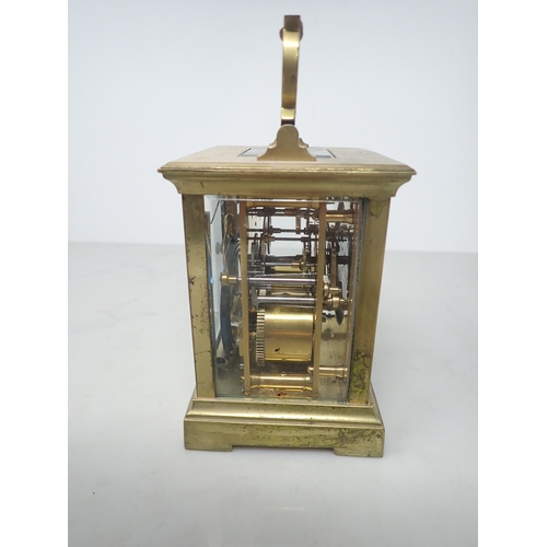 405 - A French brass cased Carriage Clock with white enamel rectangular dial, lever escapement striking on... 