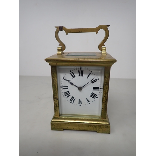 405 - A French brass cased Carriage Clock with white enamel rectangular dial, lever escapement striking on... 