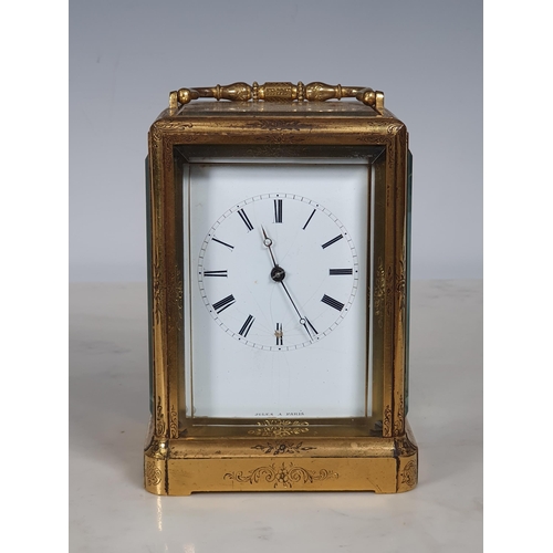 410 - A 19th Century French engraved brass cased Carriage Clock, with white enamel dial marked with Roman ... 