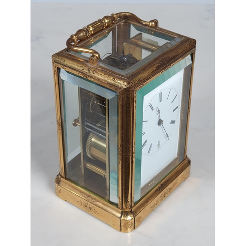 410 - A 19th Century French engraved brass cased Carriage Clock, with white enamel dial marked with Roman ... 