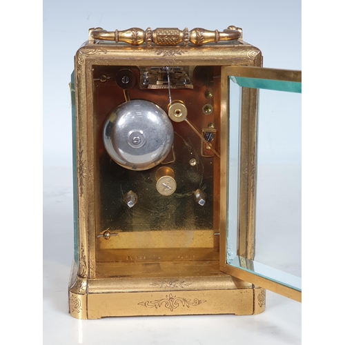 410 - A 19th Century French engraved brass cased Carriage Clock, with white enamel dial marked with Roman ... 