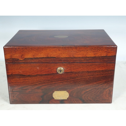 423 - A 19th Century rosewood ladies Dressing Case, with plated fitted interior, the interior of the cover... 