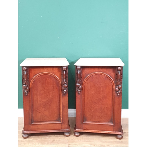 463 - A pair of 19th Century mahogany Bedside Chests with marble tops and raised on later turned supports,... 