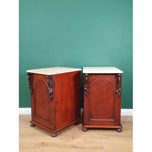 463 - A pair of 19th Century mahogany Bedside Chests with marble tops and raised on later turned supports,... 