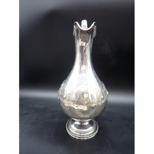 48 - A Victorian silver Claret Jug of baluster form with floral embossing, scroll engraving, vacant carto... 