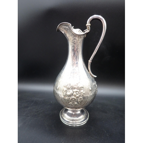 48 - A Victorian silver Claret Jug of baluster form with floral embossing, scroll engraving, vacant carto... 