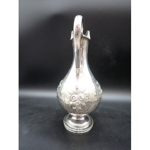 48 - A Victorian silver Claret Jug of baluster form with floral embossing, scroll engraving, vacant carto... 