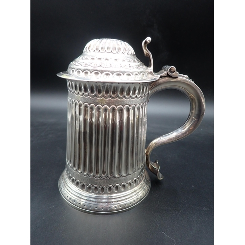 51 - A George II silver Tankard with domedlid, having volute thumb piece. fluted body with scroll and sca... 