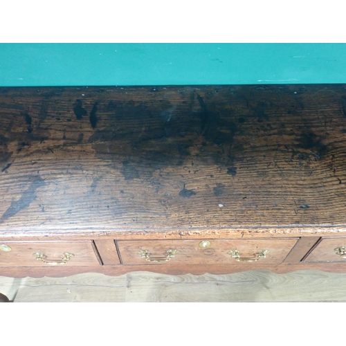 520 - An 18th Century oak Dresser Base with thick moulded top fitted three frieze drawers above shaped apr... 