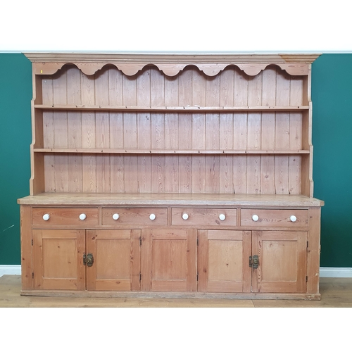 527 - A large 19th Century pine Dresser, the enclosed base with thick top above four drawers and four pane... 