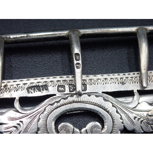 8 - A Victorian silver Nurse's Buckle of shaped rectangular form with pierced and engraved scroll design... 