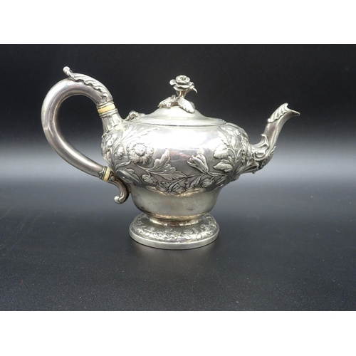 81 - A William IV silver Teapot of ogee form, finely embossed floral branches, flower finial engraved cre... 