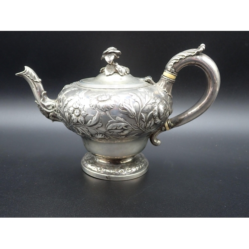 81 - A William IV silver Teapot of ogee form, finely embossed floral branches, flower finial engraved cre... 