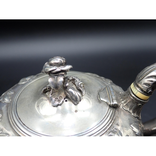 81 - A William IV silver Teapot of ogee form, finely embossed floral branches, flower finial engraved cre... 