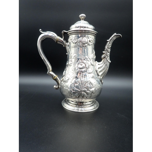 82 - A George IV silver Coffee Pot of pear shape with floral embossing, engraved crest, domed cover havin... 