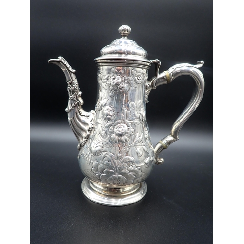 82 - A George IV silver Coffee Pot of pear shape with floral embossing, engraved crest, domed cover havin... 