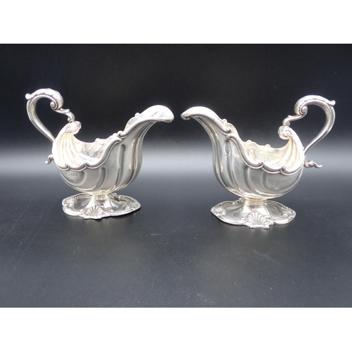 84 - An impressive pair of William IV silver Sauce Boats in the style of de Lamerie, of scallop form on p... 