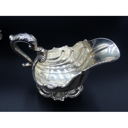 84 - An impressive pair of William IV silver Sauce Boats in the style of de Lamerie, of scallop form on p... 