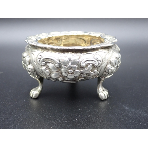 97 - A set of three William IV large silver Cauldron Salts with floral and scroll embossing, raised on pa... 