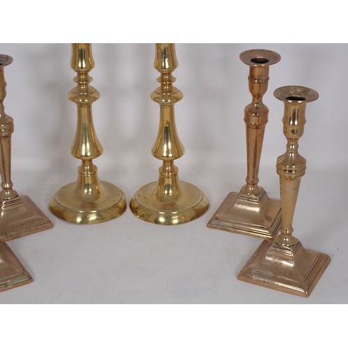 345 - A set of four 19th Century brass Candlesticks of slender baluster form on square bases 9 1/2in H and... 