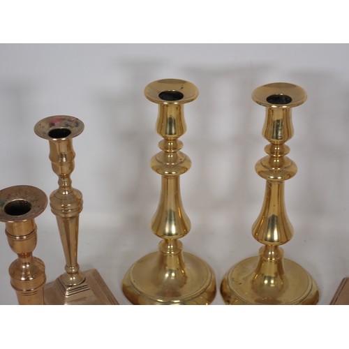 345 - A set of four 19th Century brass Candlesticks of slender baluster form on square bases 9 1/2in H and... 