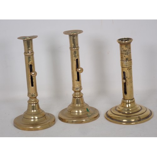 347 - A pair of 18th Century brass Ejector Candlesticks of barrel form on circular bases 7 1/2in H and ano... 