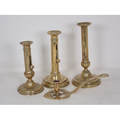 348 - Three 19th Century brass Ejector Candlesticks 7in, 8in and 9in H, and a brass heart shaped Chamber S... 