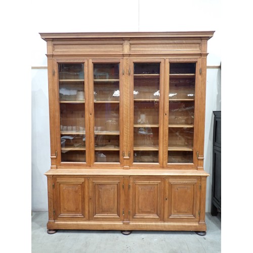 534 - A large French oak Bookcase, the upper section fitted four glazed doors enclosing adjustable shelves... 