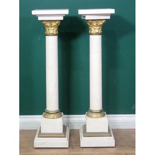 531 - A pair of white marble Columns in the classical manner with gilded metal Corinthian capital, mounted... 