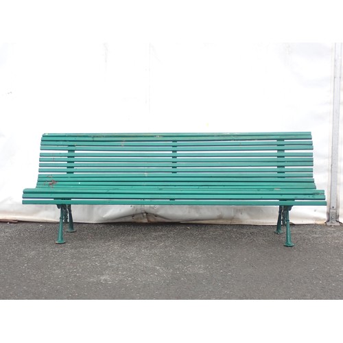 385 - A green painted Garden Bench with wooden slats on cast iron leafage and scroll supports 6ft 9in W x ... 