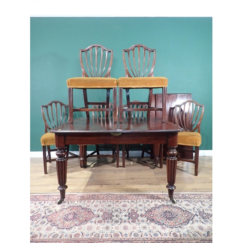 462 - A Victorian mahogany extending Dining Table with pull out action, and three spare leaves mounted upo... 